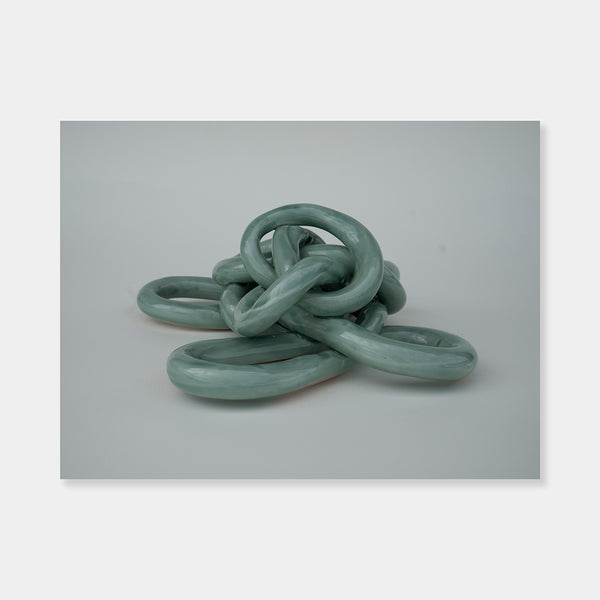 Artsuite - Sangsun Bae - Gordian Knot 1 - Sculpture - Ceramic -9" x 9" x 4"- Bae expresses herself through soft and graceful lines and interlocking curves. By using organic forms, her work has a flowing elegance demonstrating complete abstraction. This basic element in her work reflects the stoic style of expression that invokes ties to Buddhism.