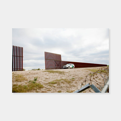 Artsuite - Susan Harbage Page - Border Wall, Border Patrol Car, and Barbed Wire - Photography - Edition 1 of 5 - 44" x 60" - Border Works - The eleven year U.S.–Mexico Border Project touches on many topics including gender, immigration, and migration, and rethinks the ways in which we look at diversity, identity, and difference.  Border Wall, Border Patrol Car, and Barbed Wire, Progreso, Texas, 2012.