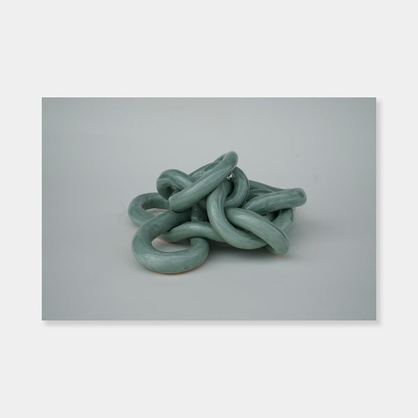 Artsuite - Sangsun Bae - Gordian Knot 1 - Sculpture - Ceramic -9" x 9" x 4"- Bae expresses herself through soft and graceful lines and interlocking curves. By using organic forms, her work has a flowing elegance demonstrating complete abstraction. This basic element in her work reflects the stoic style of expression that invokes ties to Buddhism.