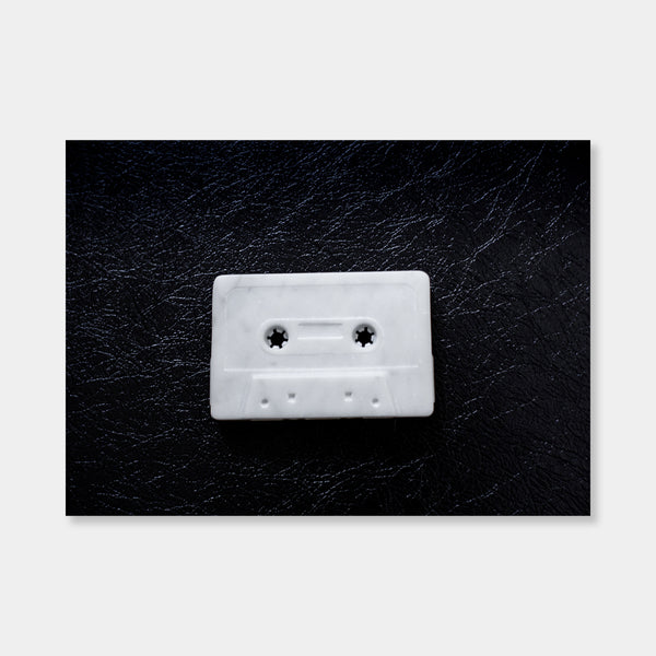 Artsuite - Peter Oakley - Cassette Tape - Original sculpture out of marble.  Oakley developed his carving skills working as a stonemason, making grave markers and memorials before turning to sculpture. In his hand, the marble sculpture becomes a solid ghost of what it represents—full of physical presence, but missing the functionality of the object.