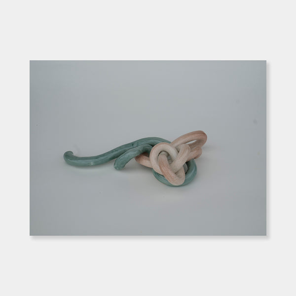 Artsuite - Sangsun Bae - Ribbon 2 - Sculpture - Ceramic -11" x 6" x 3"- Bae expresses herself through soft and graceful lines and interlocking curves.  By using organic forms, her work has a flowing elegance demonstrating complete abstraction.  This basic element in her work reflects the stoic style of expression that invokes ties to Buddhism.