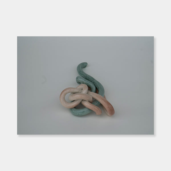 Artsuite - Sangsun Bae - Ribbon 2 - Sculpture - Ceramic -11" x 6" x 3"- Bae expresses herself through soft and graceful lines and interlocking curves. By using organic forms, her work has a flowing elegance demonstrating complete abstraction. This basic element in her work reflects the stoic style of expression that invokes ties to Buddhism.