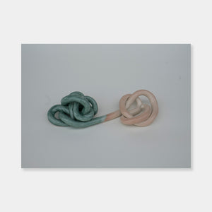 Artsuite - Sangsun Bae - Ribbon 3 - Sculpture - Ceramic -11" x 6" x 3"- Bae expresses herself through soft and graceful lines and interlocking curves. By using organic forms, her work has a flowing elegance demonstrating complete abstraction. This basic element in her work reflects the stoic style of expression that invokes ties to Buddhism.
